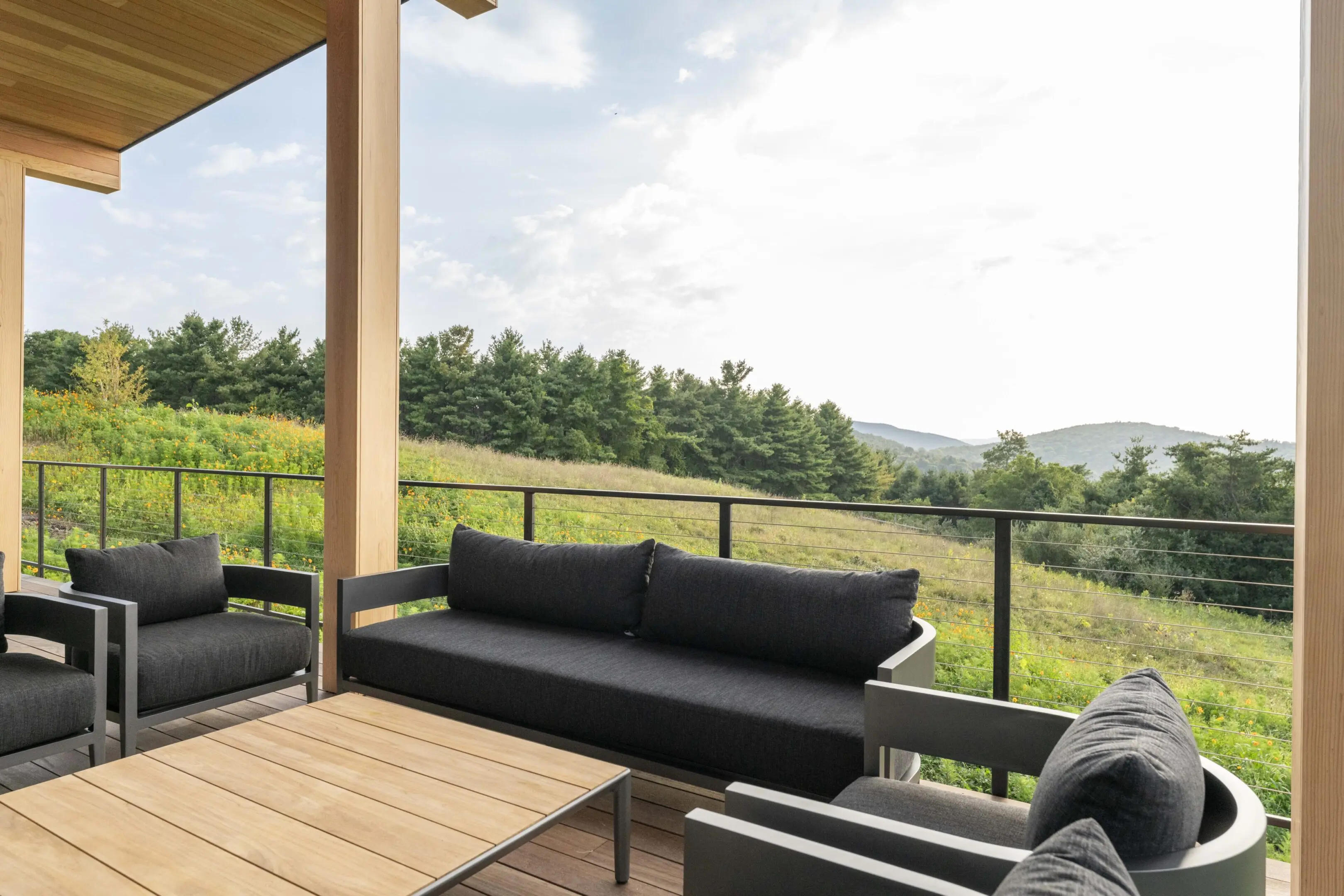 A patio with couches and tables on top of it.