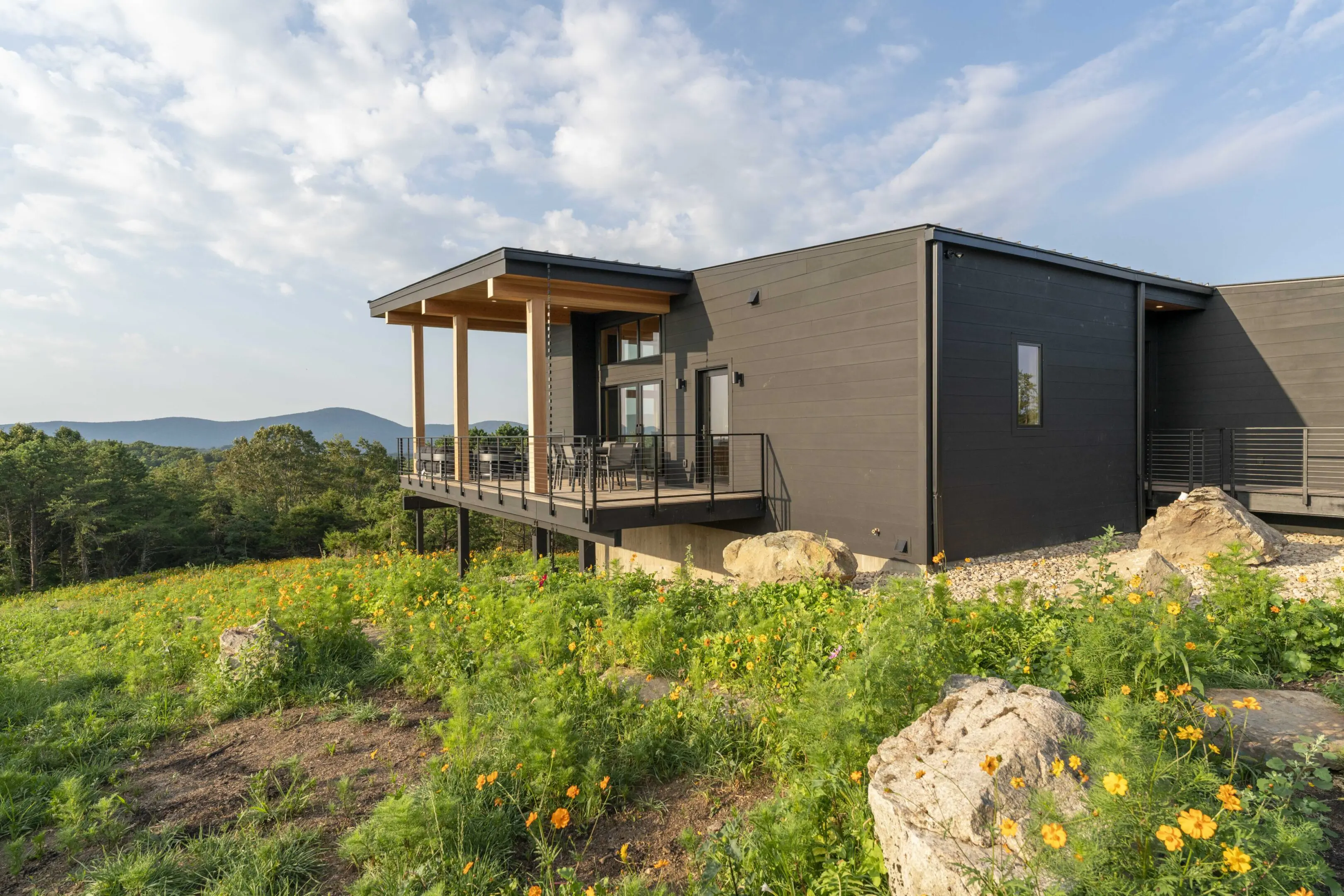 A house with a balcony and a deck on top of it.