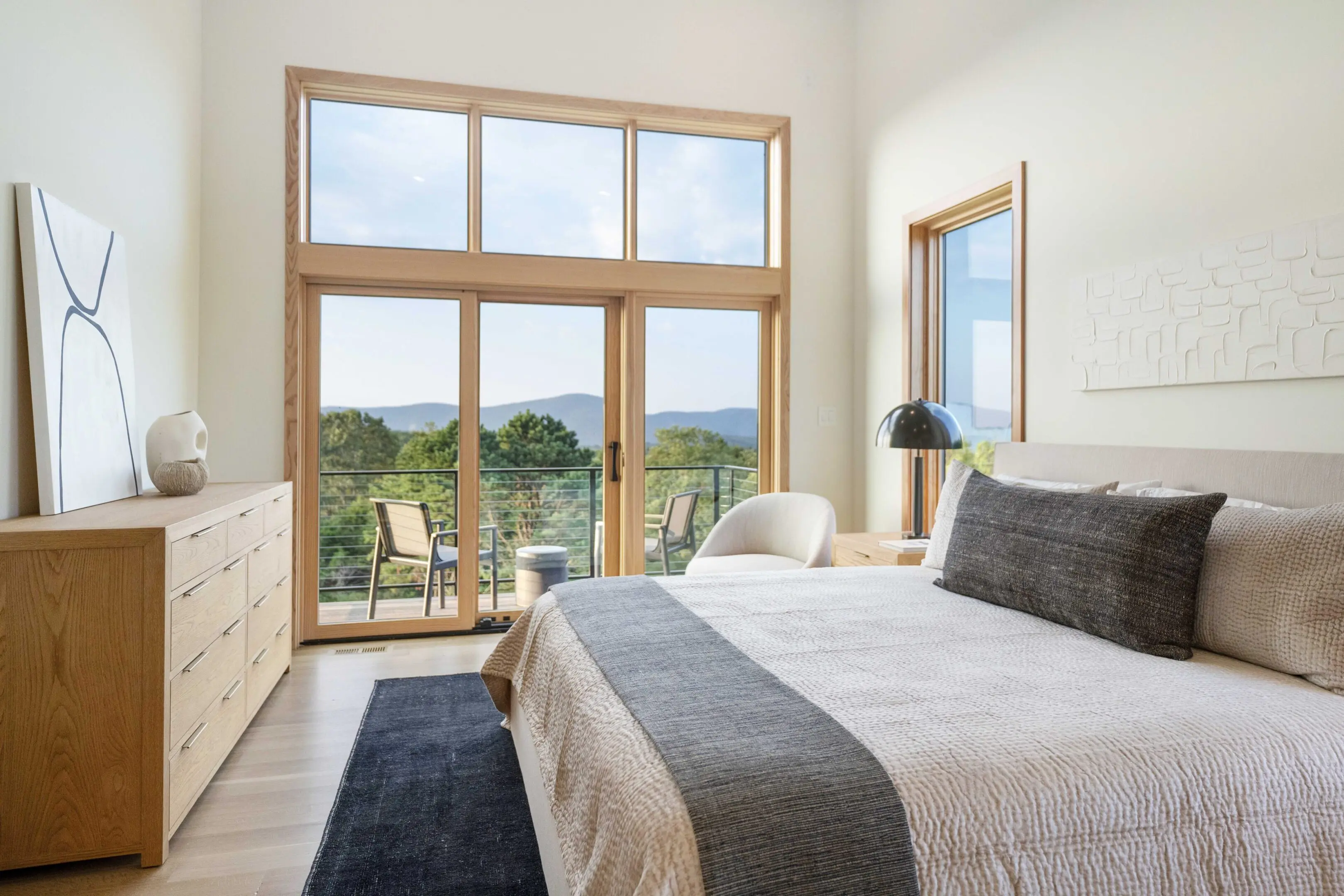 A bedroom with a large bed and a view of the mountains.