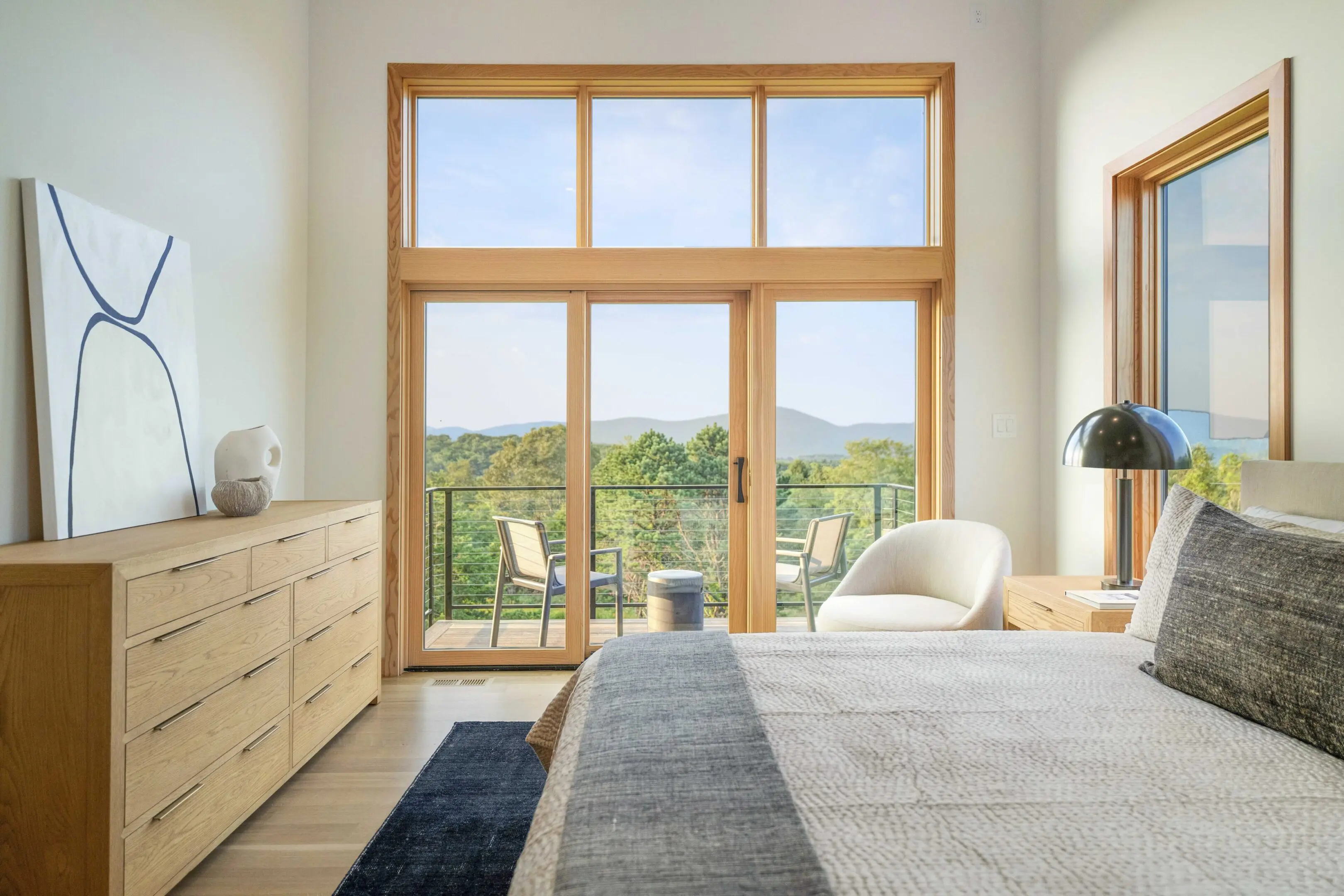 A bedroom with sliding glass doors and a view of the mountains.
