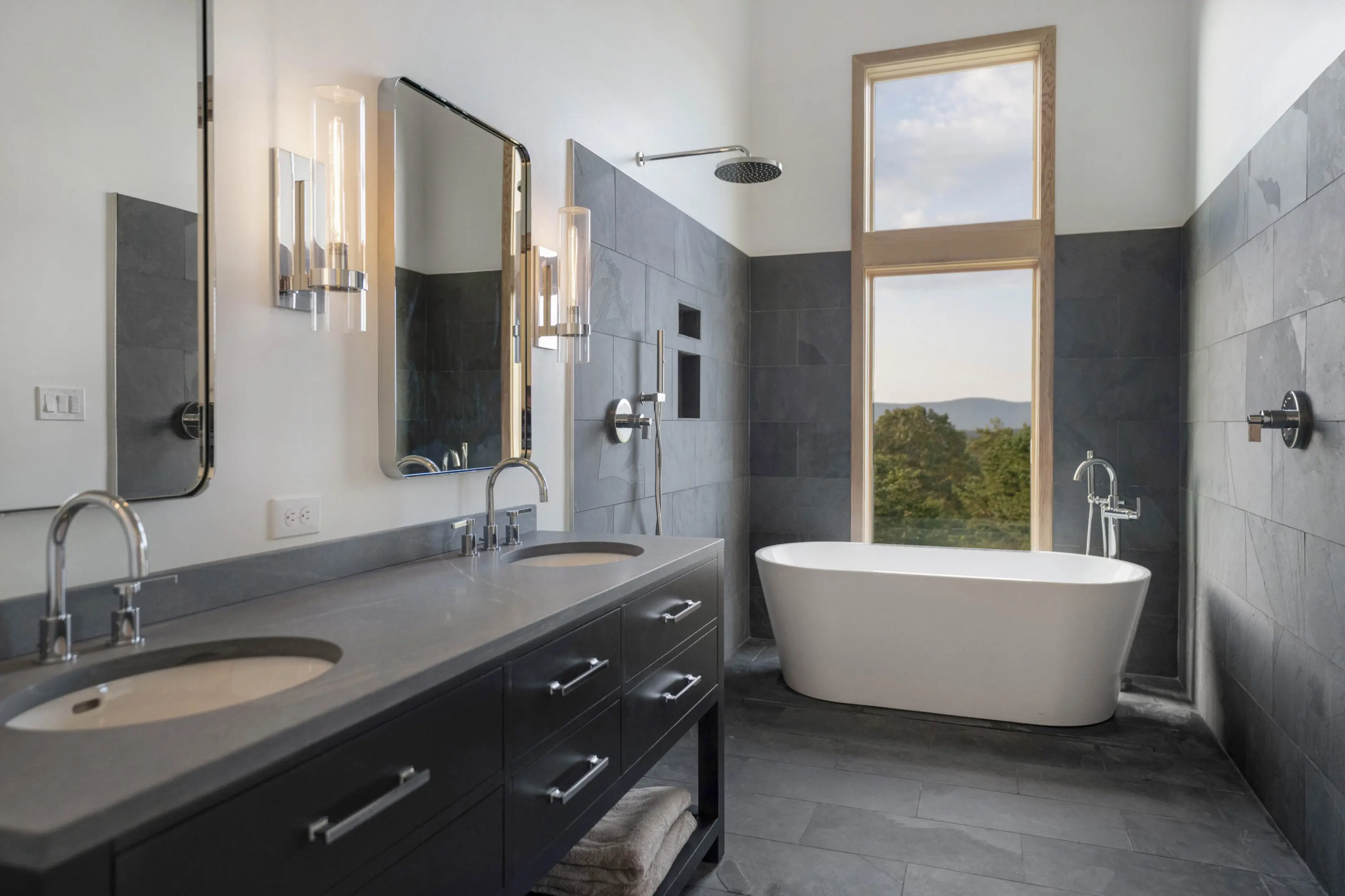 A bathroom with two sinks and a tub