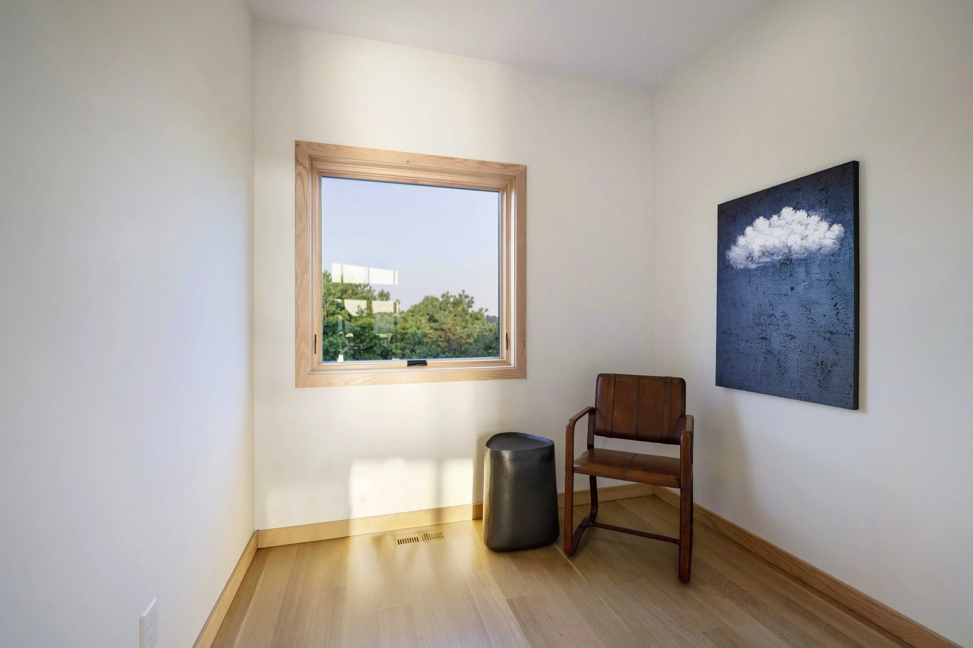 A room with a chair and suitcase in it