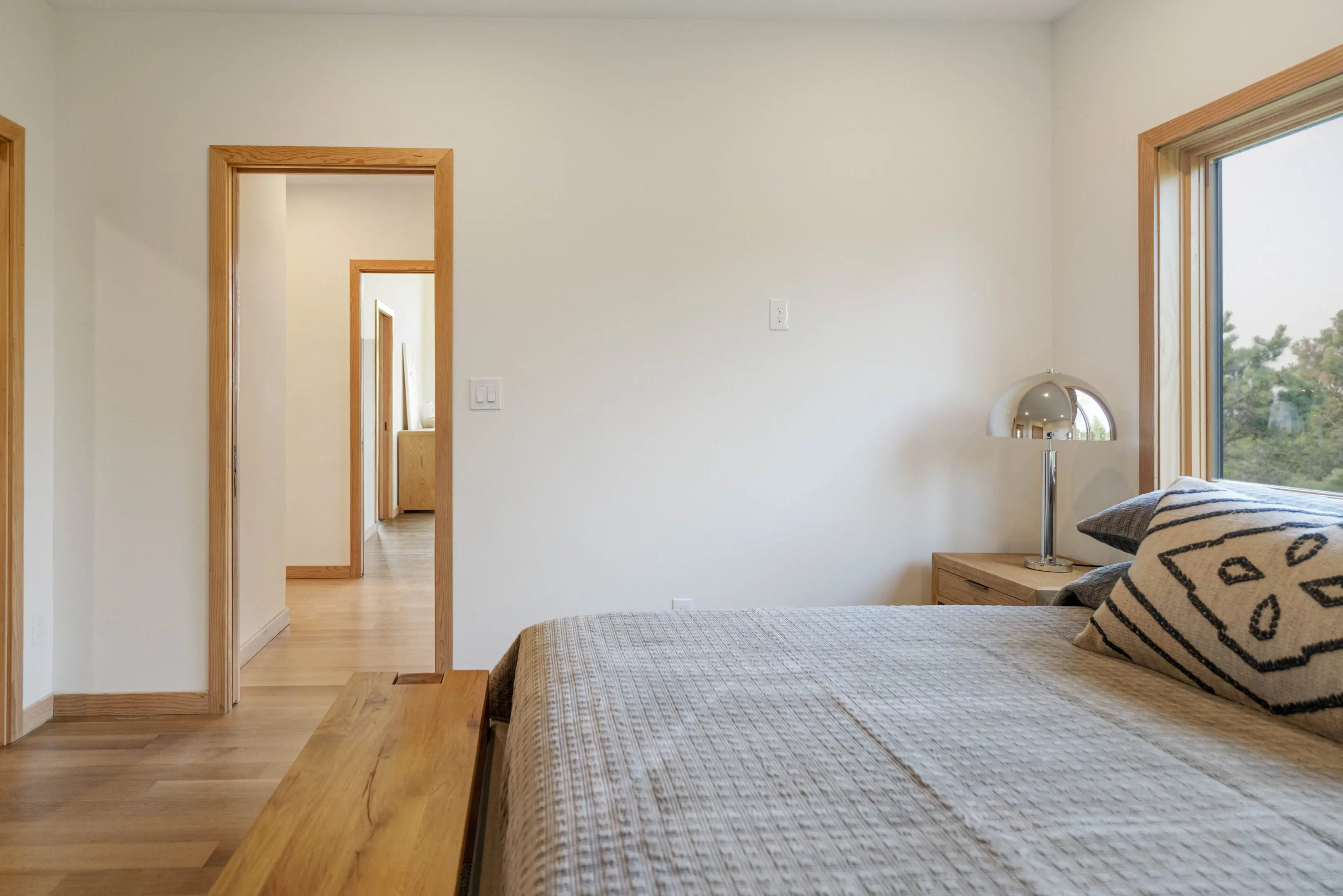 A bedroom with a bed and two nightstands.