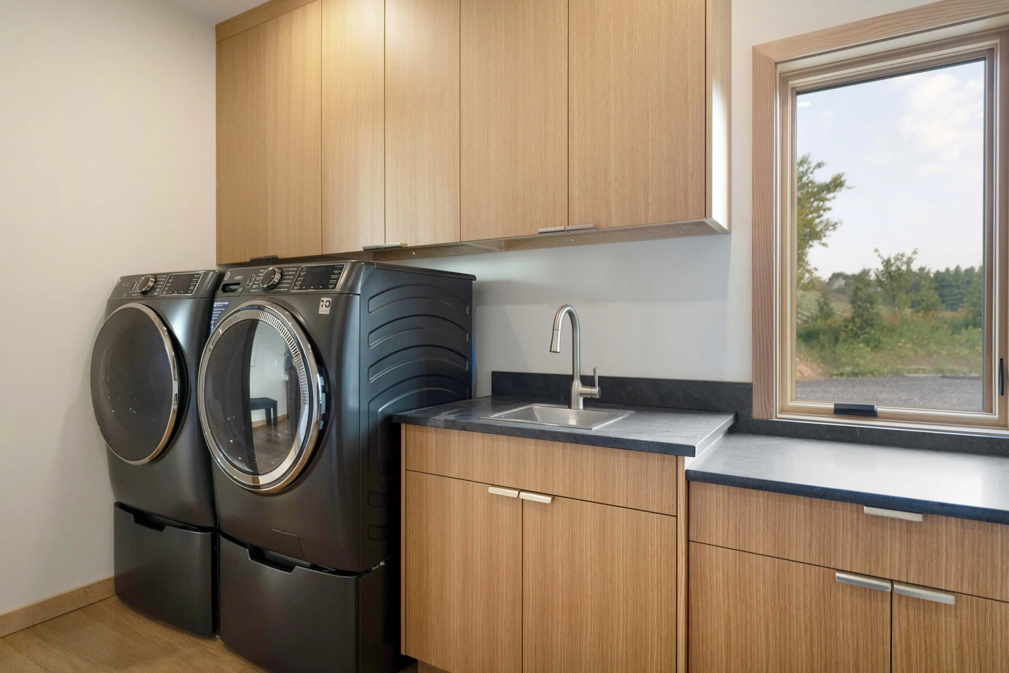 A black washer and dryer in a room.