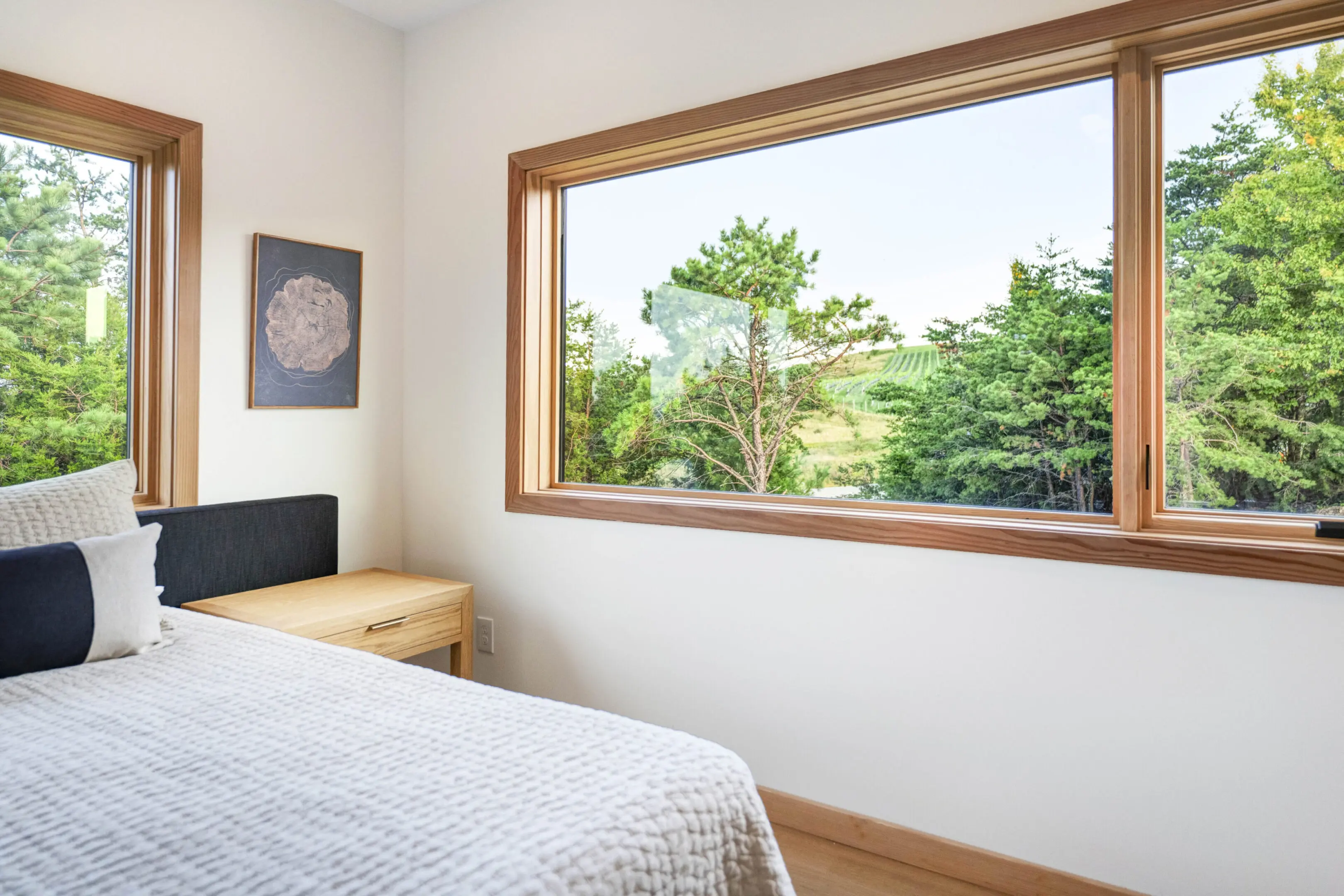 A bedroom with a bed and a window