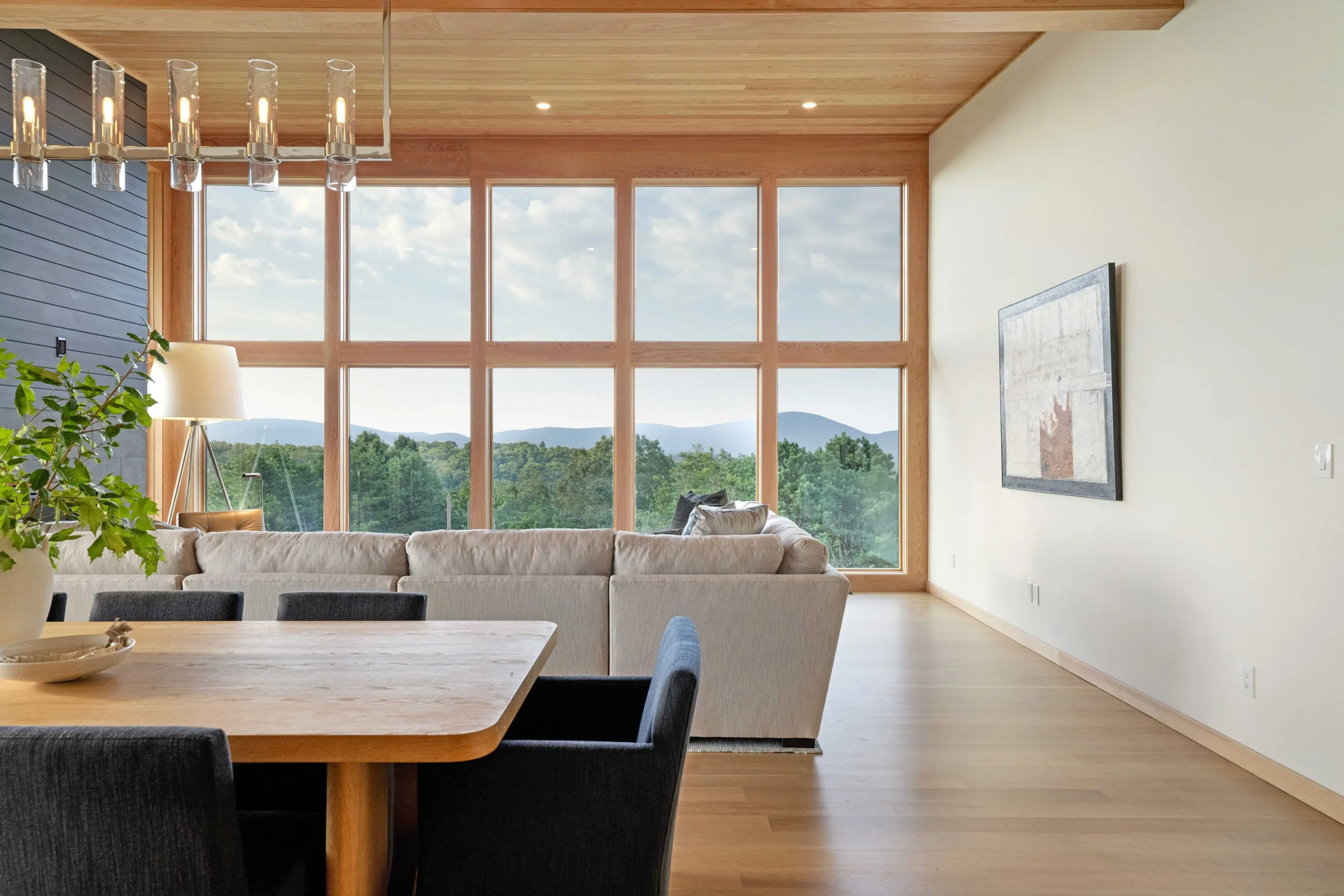 A living room with a large window and a table