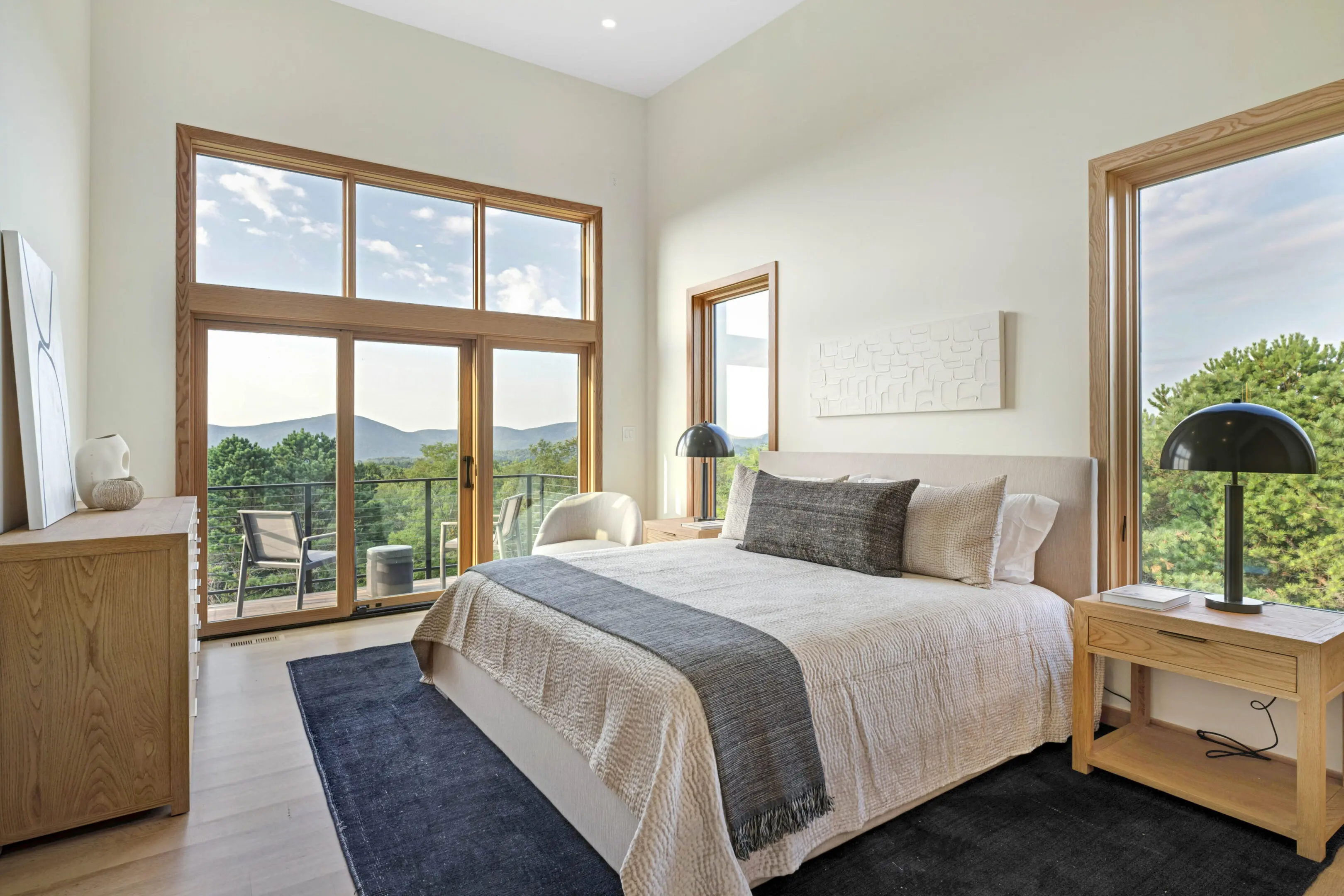 A bedroom with a large bed and a view of the mountains.