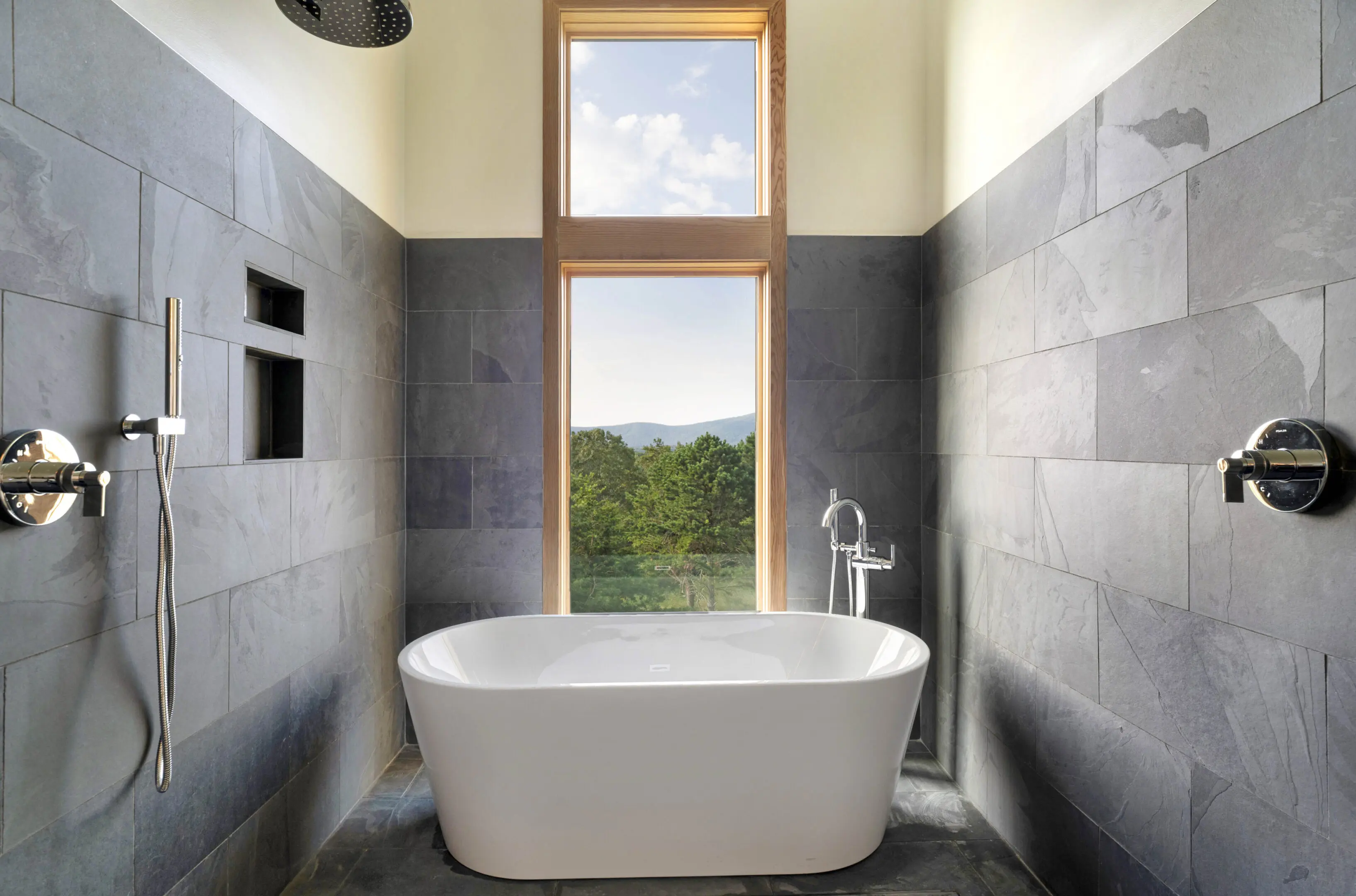 A bathroom with a tub and window in it