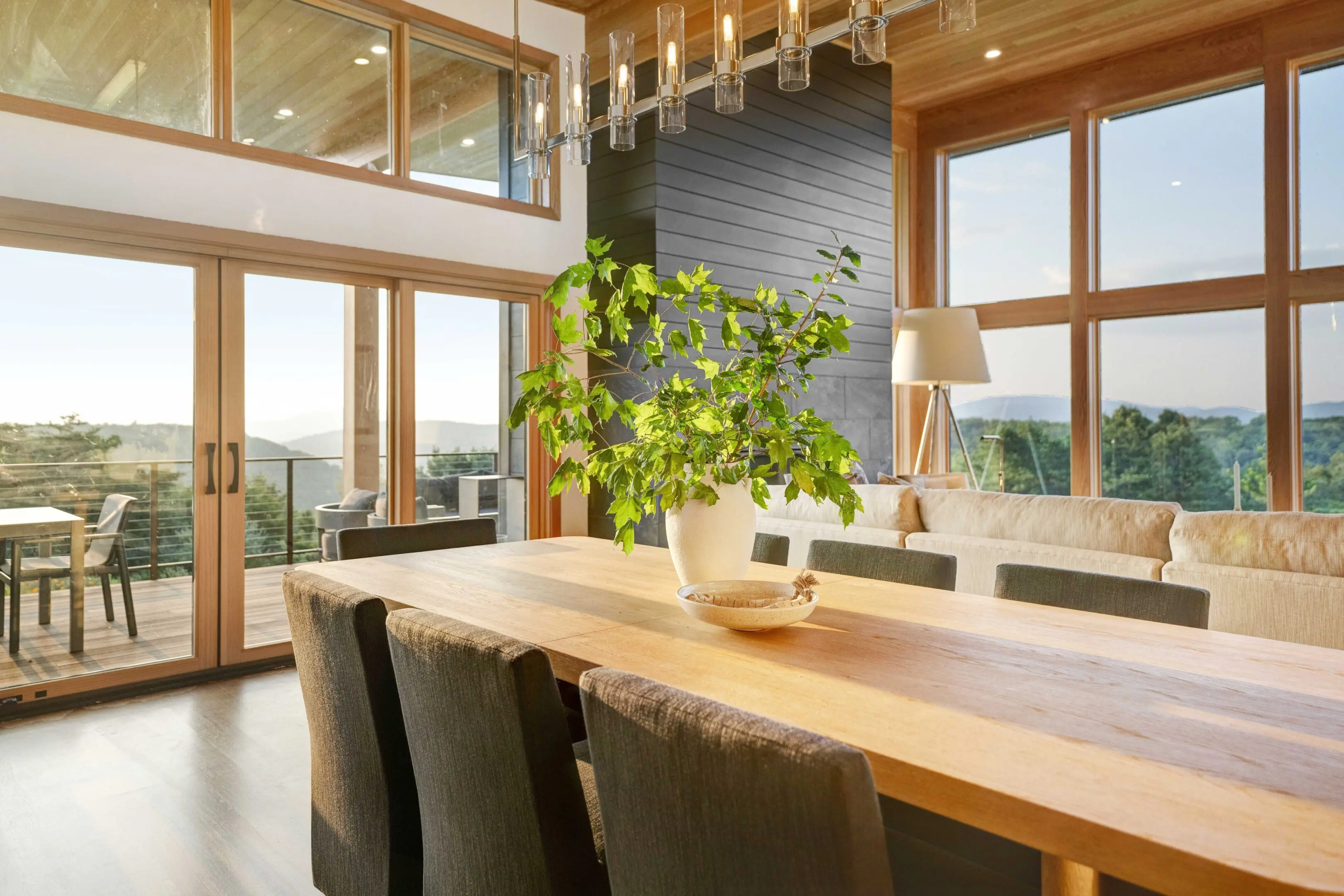 A dining room table with chairs and a plant in the middle.