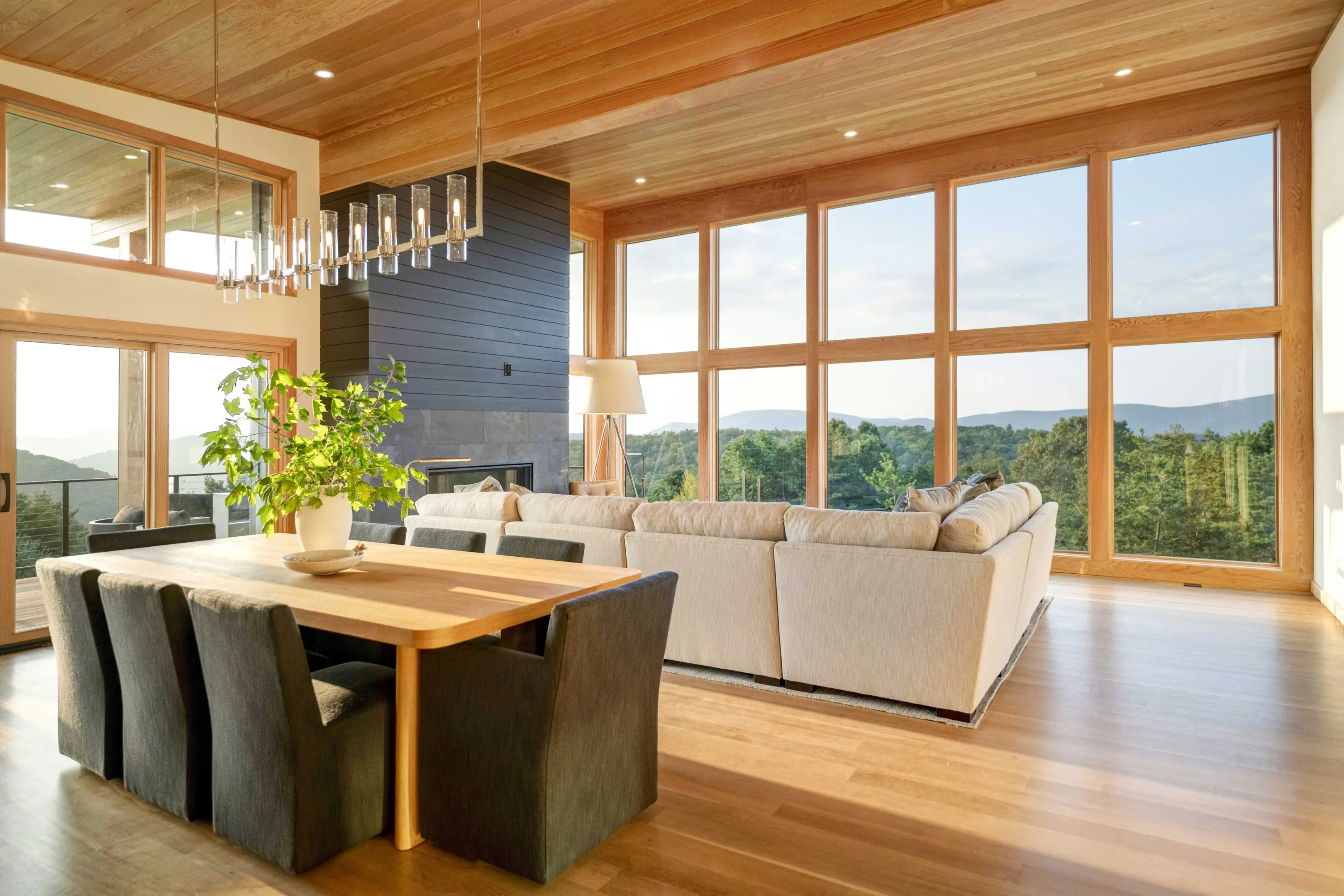 A living room with wood floors and large windows.