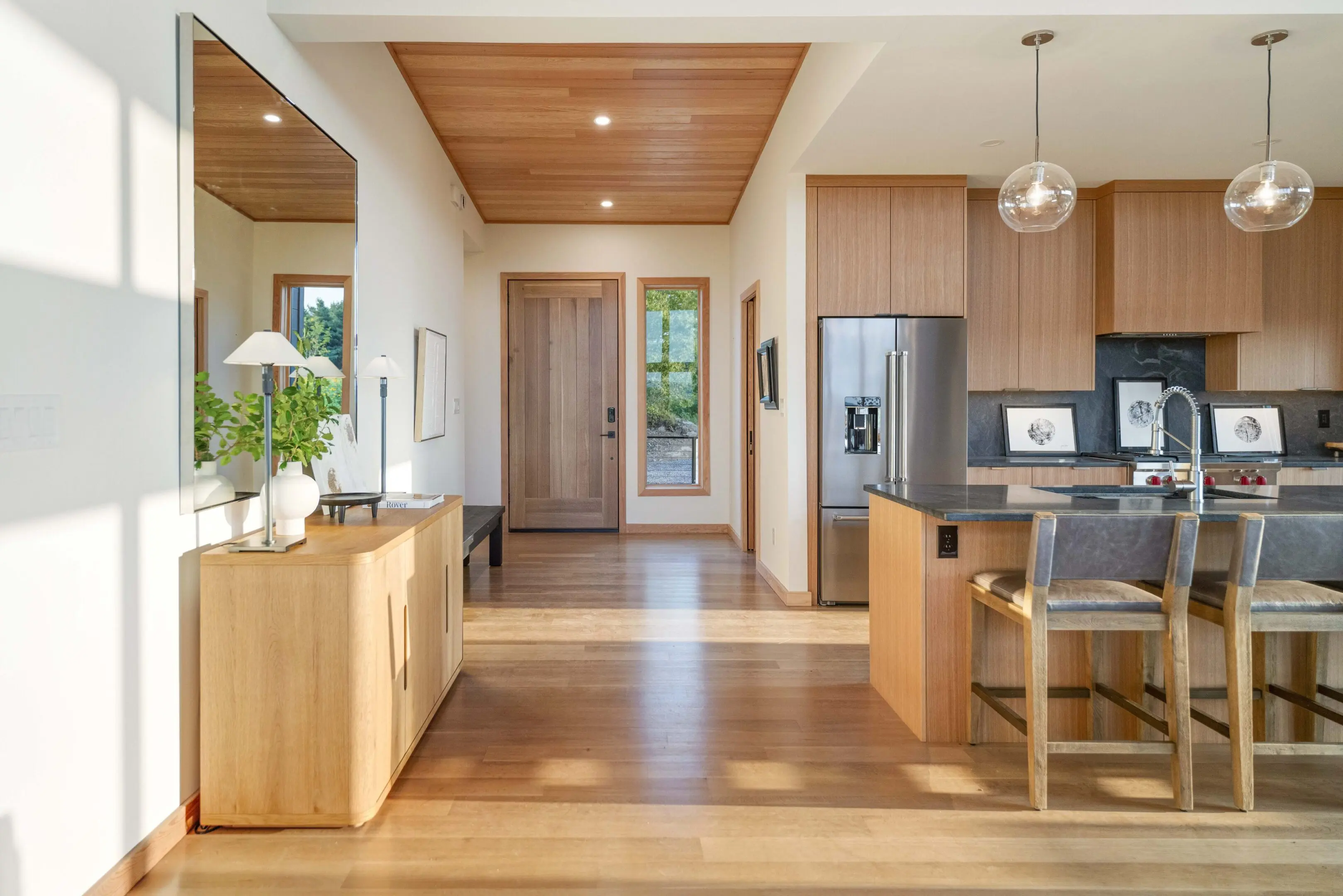 A kitchen with wood floors and white walls.