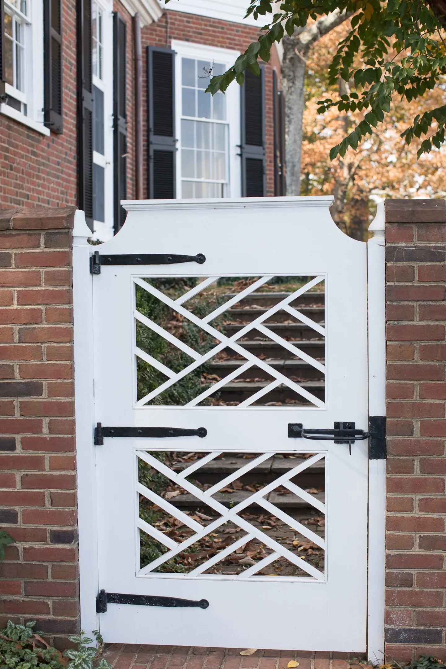 A white gate with black metal handles and latches.