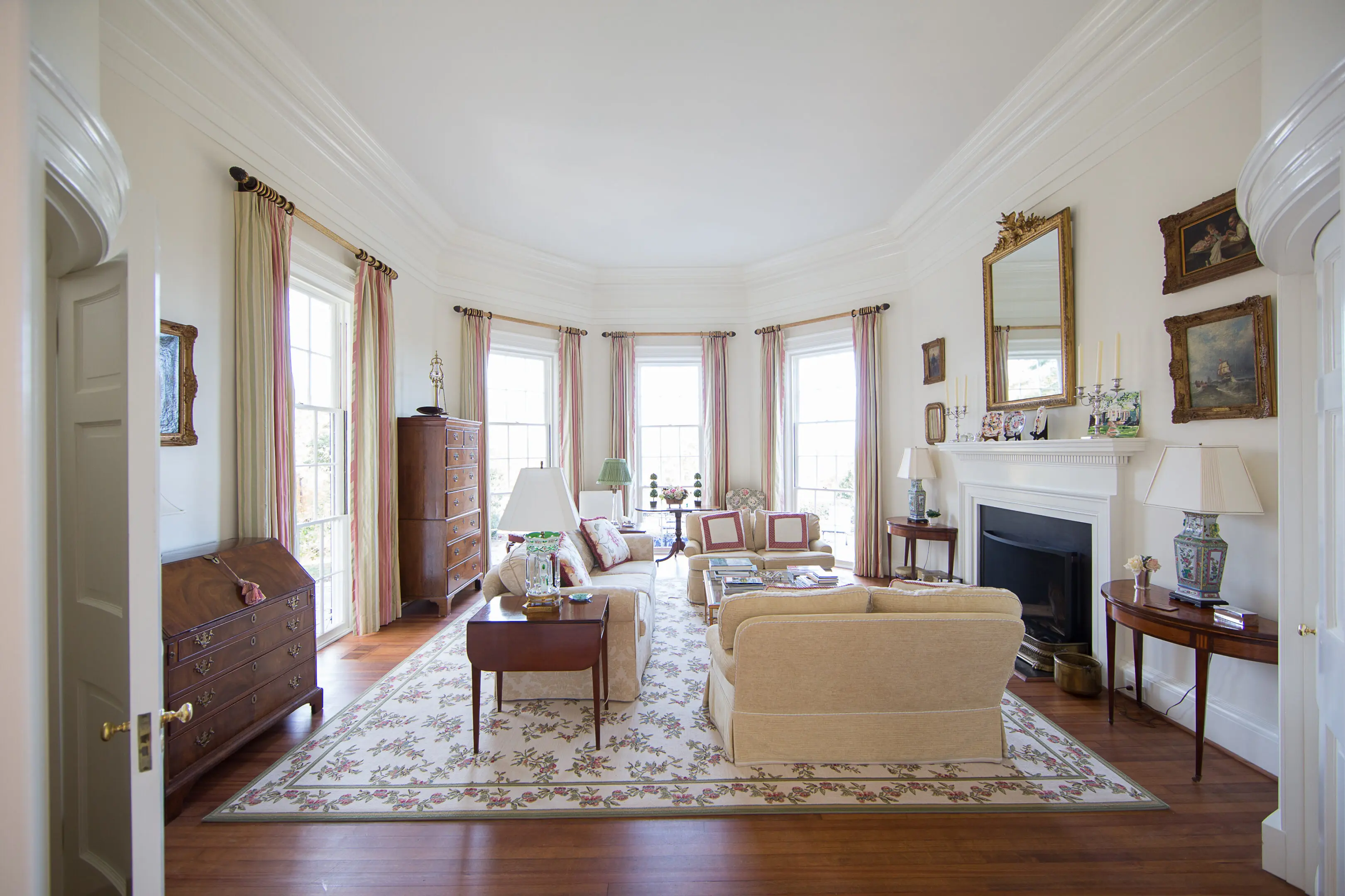 A living room with a fireplace and many windows
