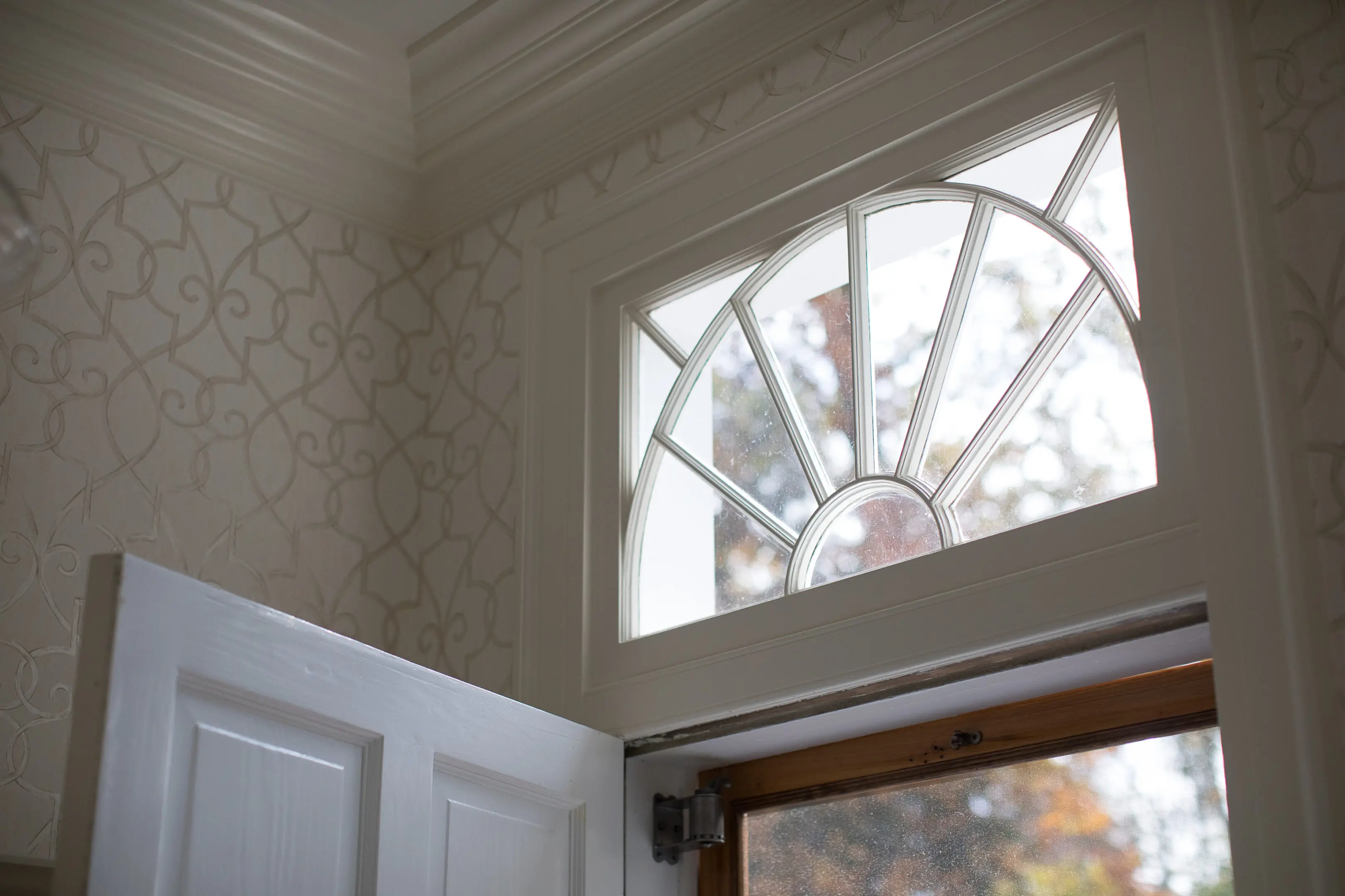 A window with a white frame and a sun light