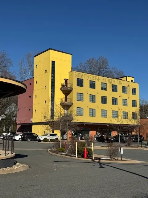task14 A yellow building with trees in the background