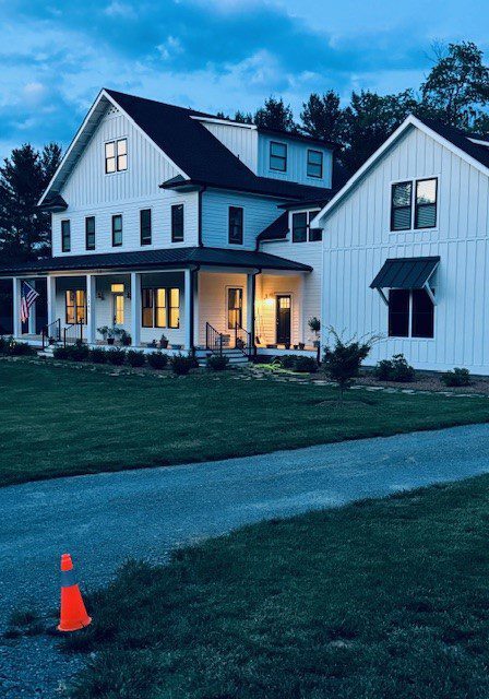 House at dusk A house with a long driveway and a street light.