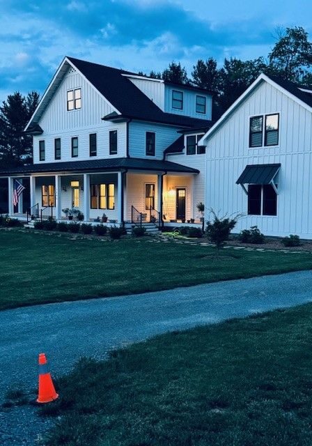 House at dusk A house with a long driveway and an orange cone.